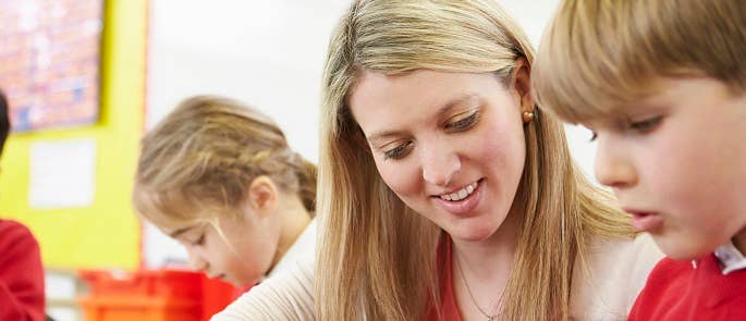 Teacher instructing pupil