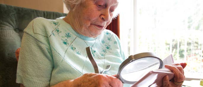 An elderly lady reading a book