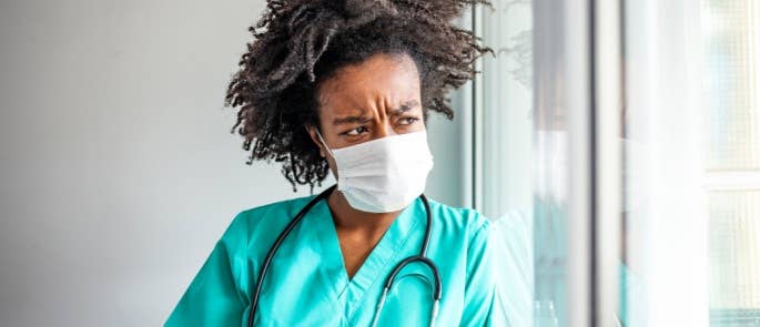 Healthcare professional looking out of a window