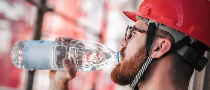 Construction worker drinking water