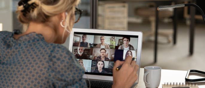 A woman taking part in a meeting while working from home