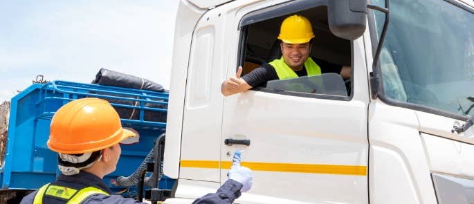 Banksman talking to driver of lorry