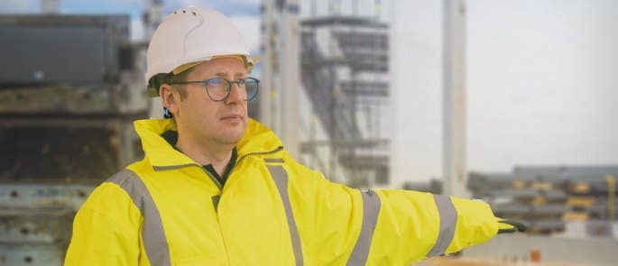 Banksman on a construction site using a hand signal