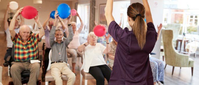 Activities coordinator leading an activity in a care home