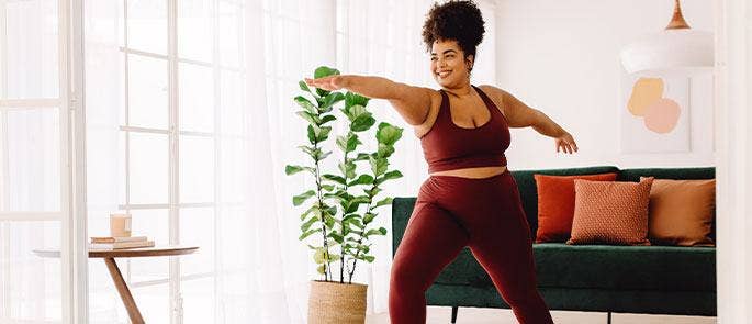 Someone doing yoga and experiencing positive emotions