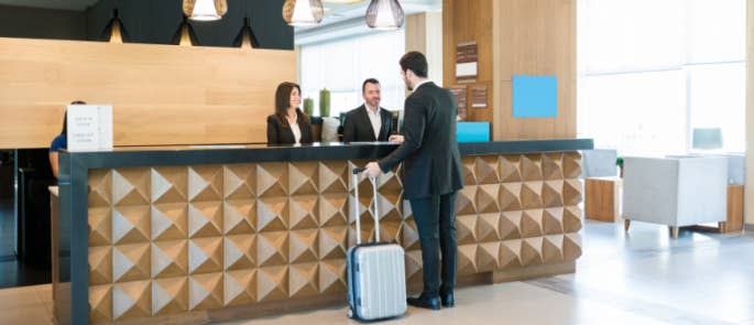 Hospitality staff checking a guest into a hotel