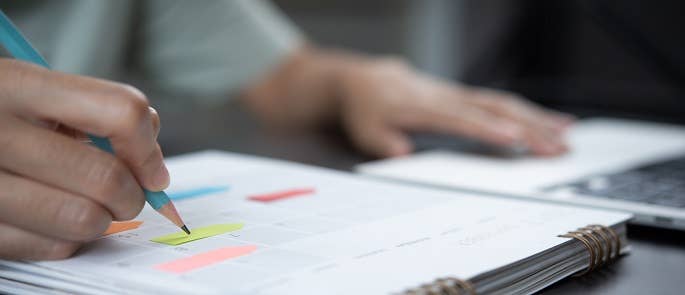 an event manager creating a business plan in a notebook