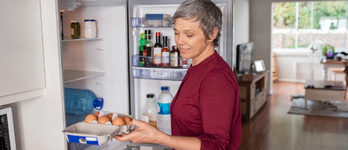 A person storing their eggs in the fridge.