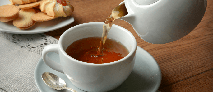 Tea being poured into a teacup 