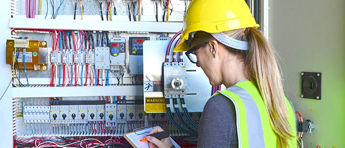 female electrician inspecting safety 