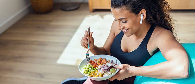 Woman eating a nutritionally balanced meal that improves her mental health