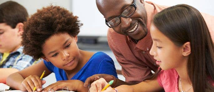 Teacher helping students