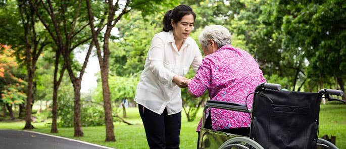 caregiver and elderly woman in the park