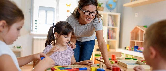 A nursery teacher working with young children