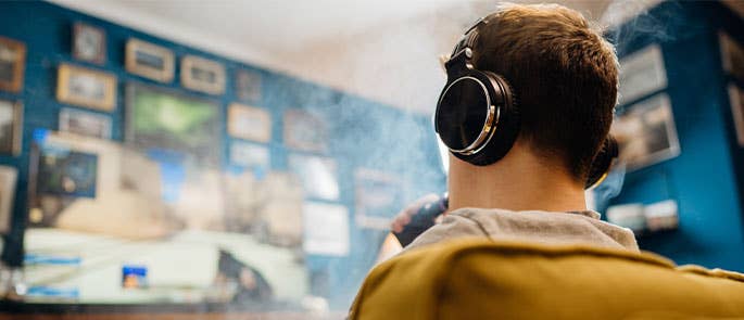 Child vaping in room with headphones on