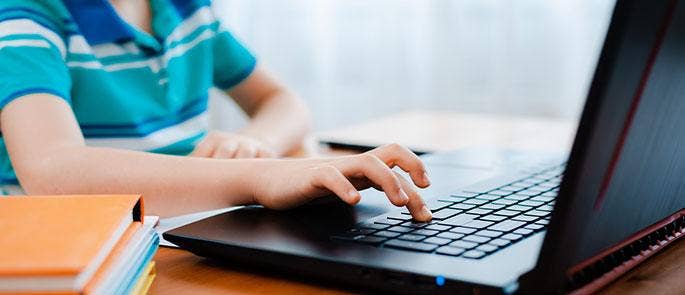 Child doing homework on the laptop