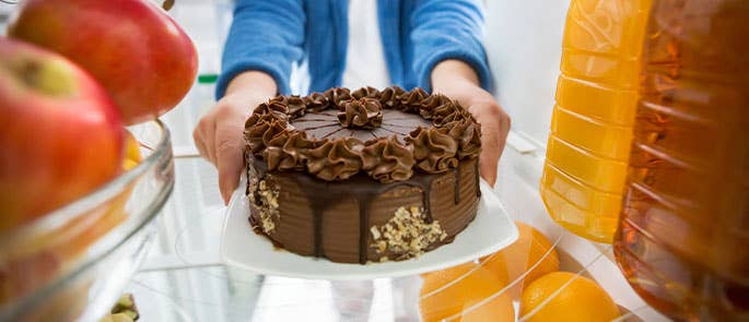 Cake being placed in the fridge for storage