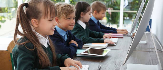 Children at school using computers and iPads
