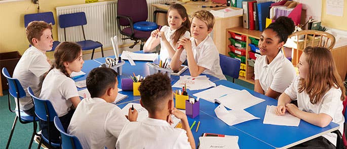 group of 8 young children working collaboratively together in a classroom