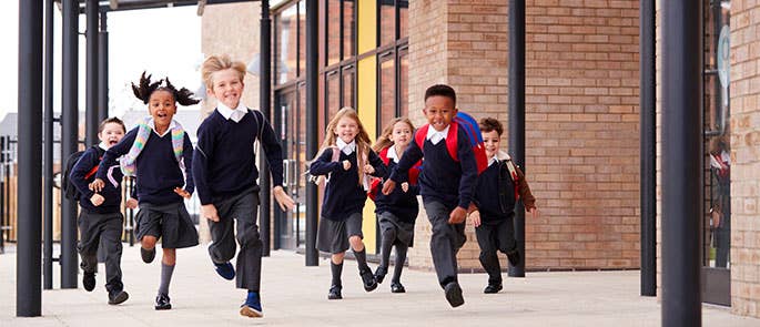 Primary school students outside a school
