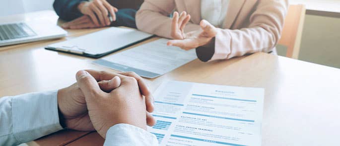 support worker interview showing the table and CV's and clipboard