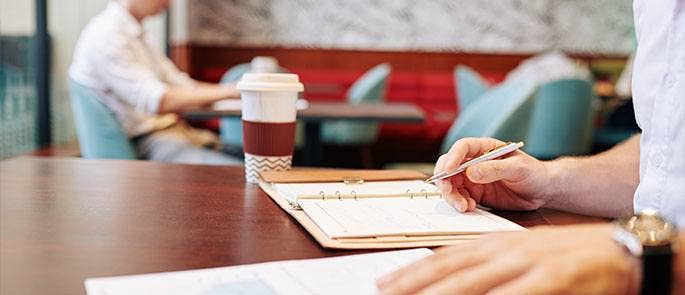 Man taking notes at a coffee shop