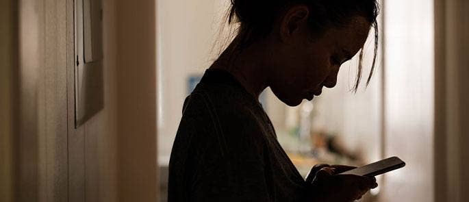 A teenager using their mobile phone