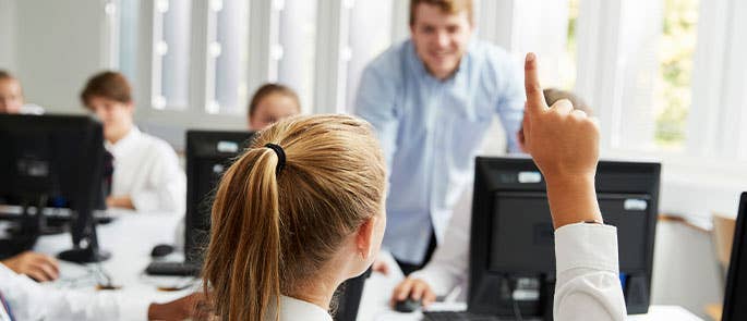 Student raising hand to ask teacher a question