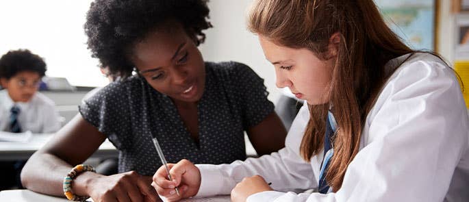 teacher helping a student in the classroom