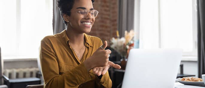employee communicating through sign language though laptop at work