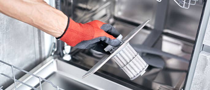 checking the filter of the dishwasher for cleaning