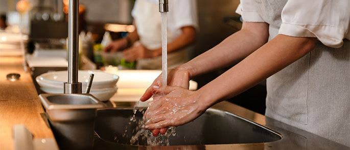 Washing hands in the kitchen sink