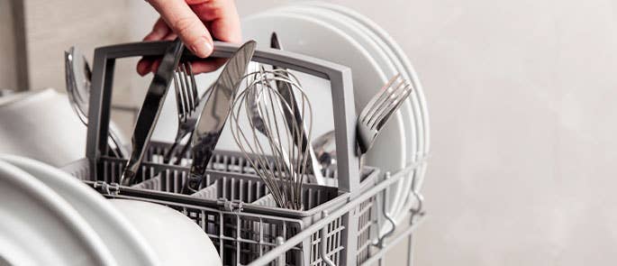 Fully loaded cutlery basket in dishwasher