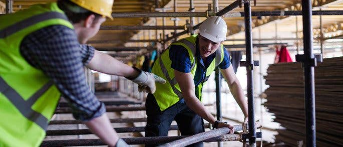 Construction workers on a construction site with scaffolding