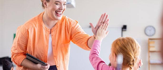 Teacher praising a child in the classroom