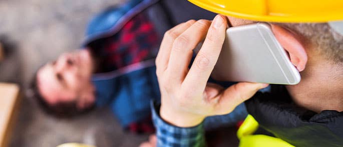 Person on the phone to paramedics/ambulance to help someone who is injured