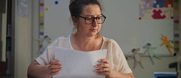 Teacher sitting at a desk in the classroom