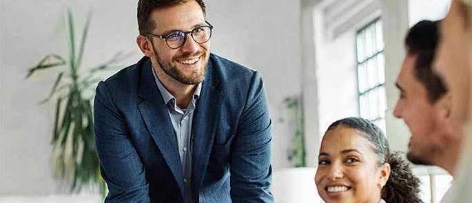 business leader in workplace talking to team