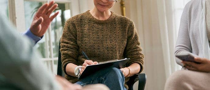 Woman using a clipboard in a meeting
