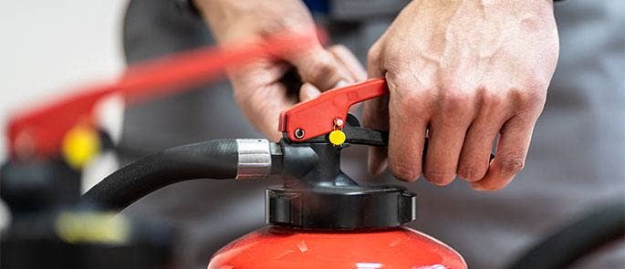 Man using a fire extinguisher