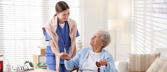 health and social care professional caring for elderly person in care home