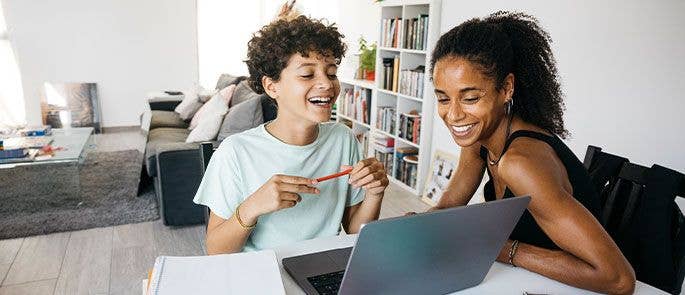 Child revising for his exams with a parent