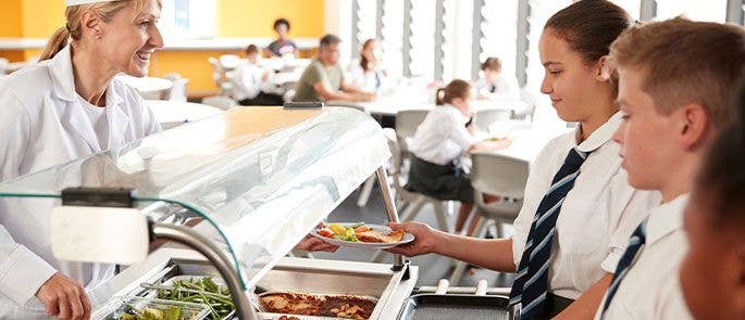 Serving dinner in the school canteen