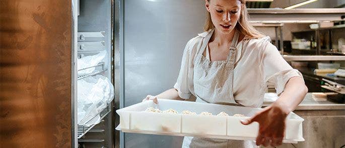 Chef putting food into the fridge