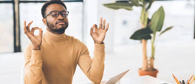 Man dealing with his stress by meditating