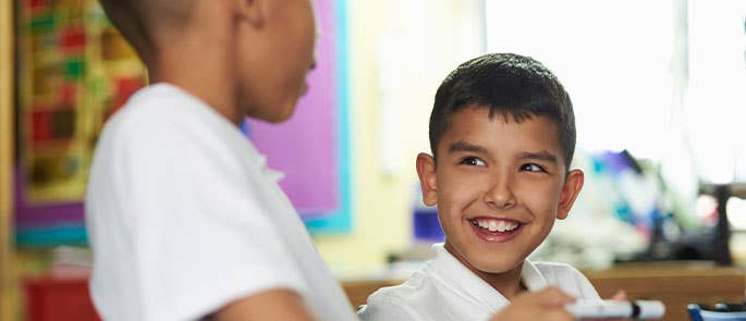 primary school children in buddy pair at school