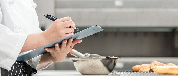 Kitchen manager making a cleaning schedule