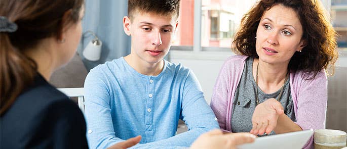Teacher talking with student and parent