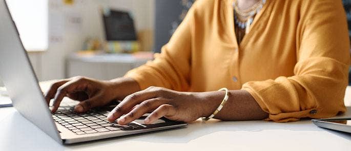 Teacher using a laptop at work