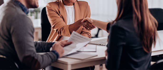 small office meeting with two people handshaking